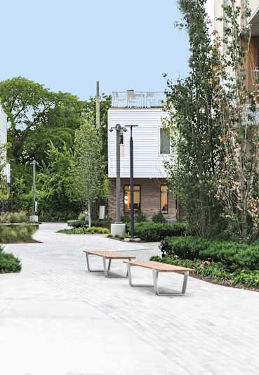 a courtyard with trees in front of a building