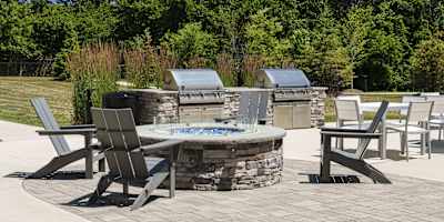 a patio with a fire pit and chairs and tables