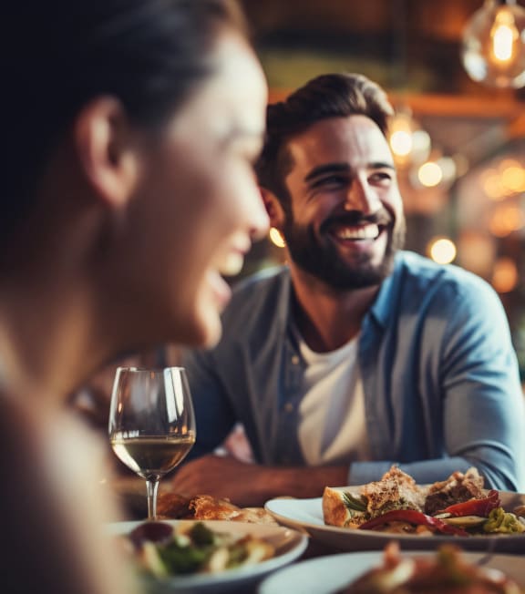 people sitting at a table in a restaurant eating food