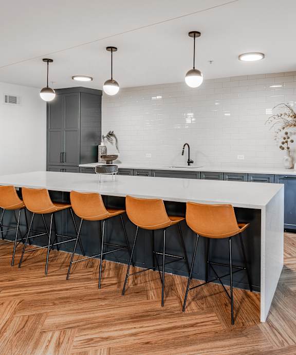 A modern kitchen with a dining table set for two.