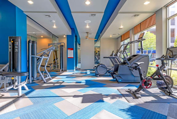 a gym with cardio machines and weights at the renaissance valencia resort and spa