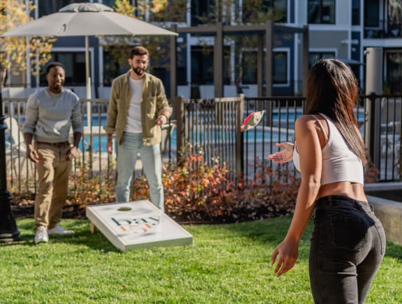 a group of people playing frisbee in a park