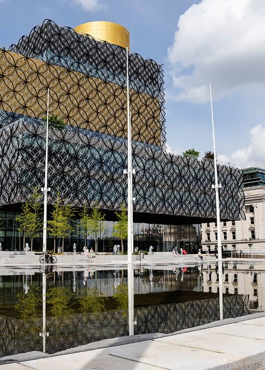 a large building with a reflection in the water