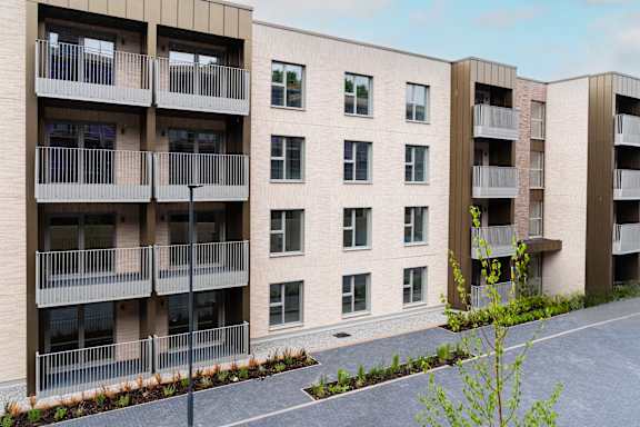 A modern apartment building with balconies and windows.at The Quarters Apartments, Dock Road