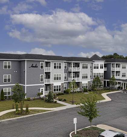 a rendering of an apartment building on a street corner