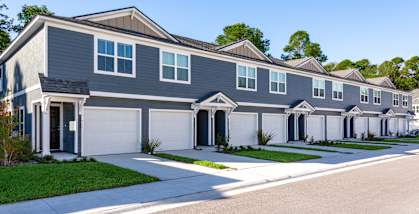 A row of houses with grey and white exteriors.