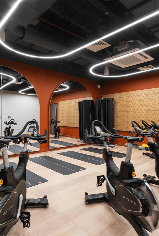a gym with spin bikes and other exercise equipment