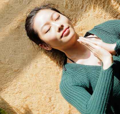 Young woman meditating on her apartment floor