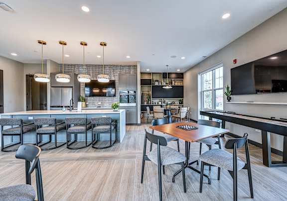 A modern kitchen with a dining table and chairs.