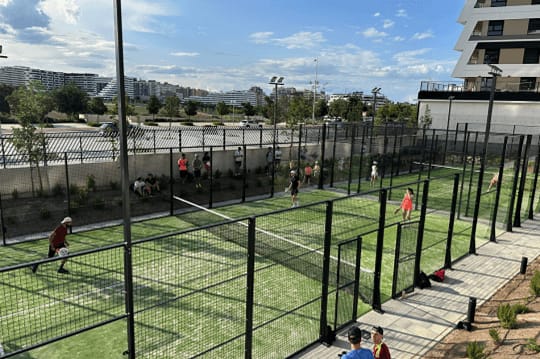 a group of people playing tennis on a tennis court