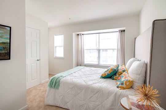 a bedroom with a bed and a window