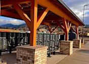 Thumbnail 9 of 27 - A row of black mailboxes under a red roof.