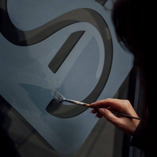 a person holding a fork in front of a sculpture of a number seven