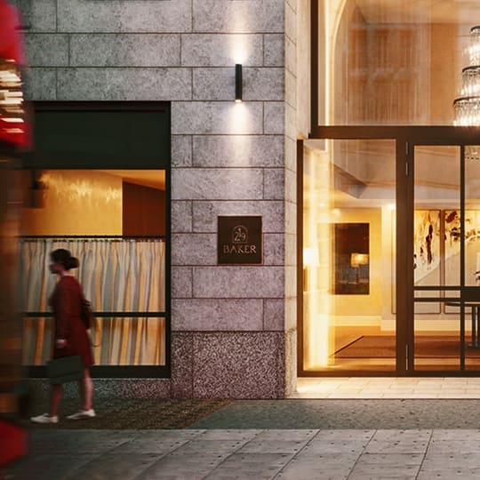 a woman walking down a street in front of a building