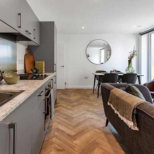 a kitchen and living room with a dining area and a sink
