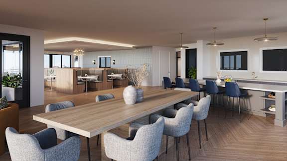 a rendering of a communal area with a dining table and chairs