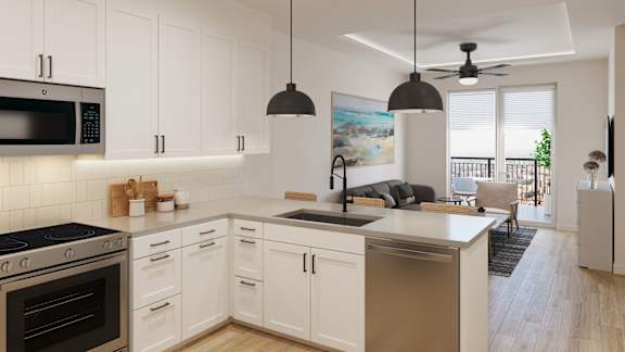 an open kitchen and living room with white cabinets and a counter top