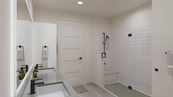 a white bathroom with a shower and a sink
