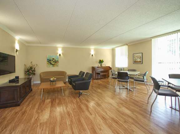 a living room with couches and chairs and a television