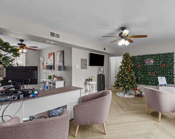 a living room with a christmas tree and a desk and chairs at Hampton Gardens, Saint Louis, 63139