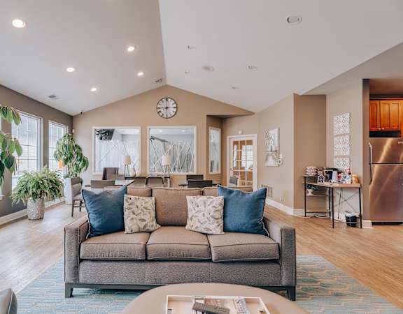 A living room with a grey couch and a coffee table.