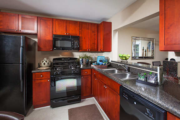 a kitchen with black appliances and granite counter tops