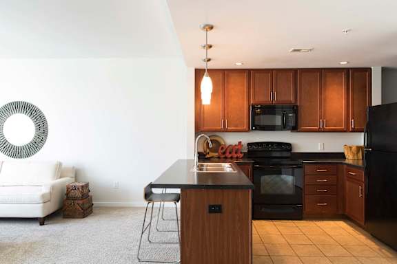 fully equipped eat-in kitchen complete with seating at an attached breakfast bar