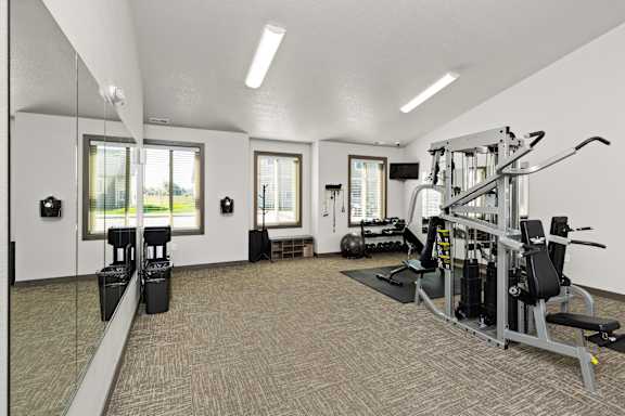 A well-equipped gym with a variety of machines and weightlifting equipment.