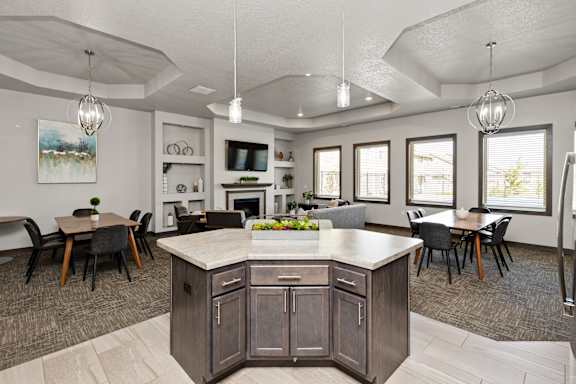 A kitchen with a large island and a dining table.
