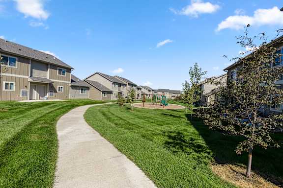 A residential area with apartment buildings and a playground.
