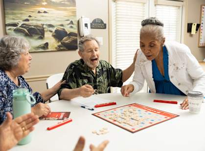 A group of elderly people playing a board game.