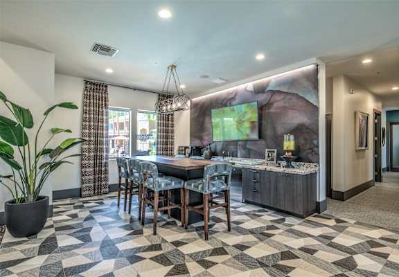 A dining room with a checkered floor and a large painting on the wall.