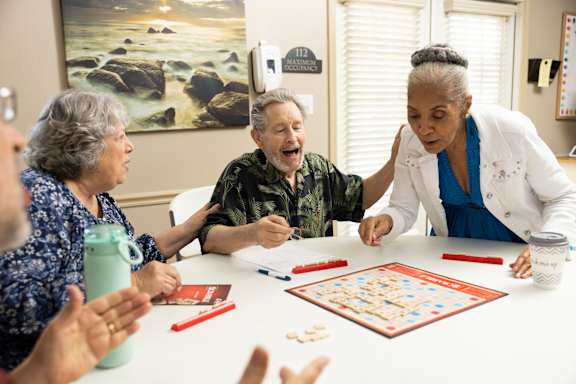 A group of elderly people playing a board game