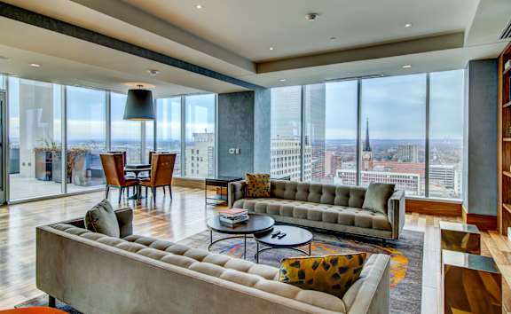 A modern living room with a large window overlooking the city.