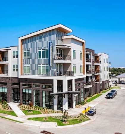 a large apartment building with a street in front of it