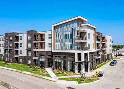 a large apartment building with a street in front of it