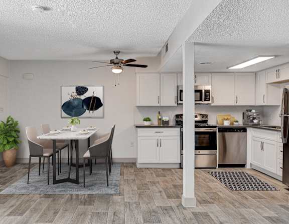 A modern kitchen with a dining table and chairs.