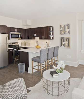 a living room and kitchen with a white couch and a table