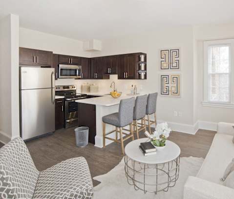 a living room and kitchen with a white couch and a table