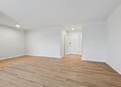 Thumbnail 41 of 59 - A room with wooden flooring and white walls.