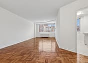 Thumbnail 20 of 59 - One bedroom living area wooden flooring and white walls.