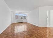 Thumbnail 21 of 59 - A room with wooden flooring and white walls.