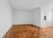 Thumbnail 47 of 59 - A room with a wooden floor and white walls.