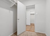 Thumbnail 40 of 59 - A white door is open to a hallway.