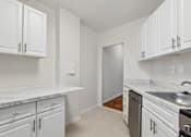Thumbnail 18 of 59 - A kitchen with white cabinets and a marble countertop.