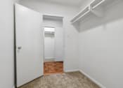 Thumbnail 46 of 59 - A white door opens to a hallway with a carpeted floor.