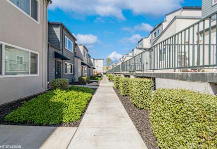 A kitchen with brown cabinets and white appliances at Oak Center Apartments, Oakland, 94607