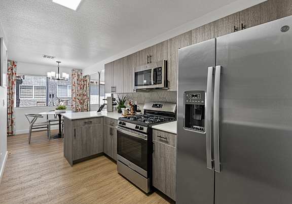 Townhomes at Horizon Ridge model kitchen with appliances and dining room