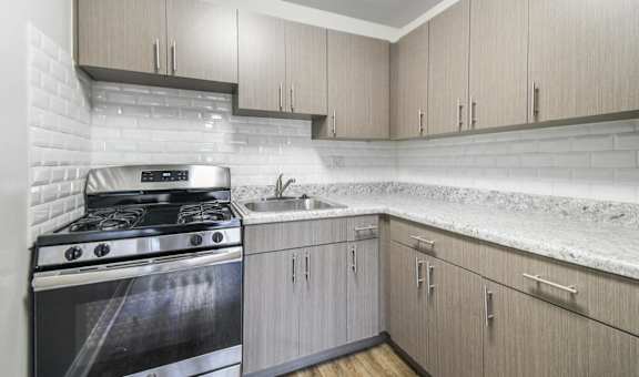 A modern kitchen with a stove and cabinets.