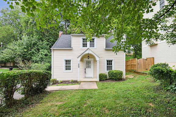 A house with a white front door and a small porch.
